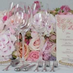 Wine glasses on decorative wedding table with flowers