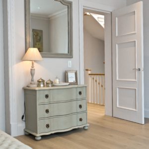 Chest of drawers with mirror and side lamp