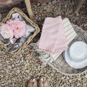 Pink napkins and tableware in wicker baskets