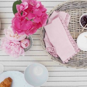 Wicker tray with peonies and breakfast