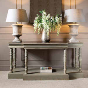 Console table with lamps and large vase flowers