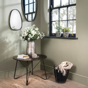 Flowers on a side table and mirror in hallway