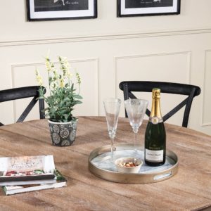 Champagne and glasses on a round tray