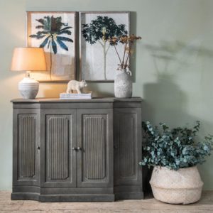 Sideboard with table lamp and botanical prints